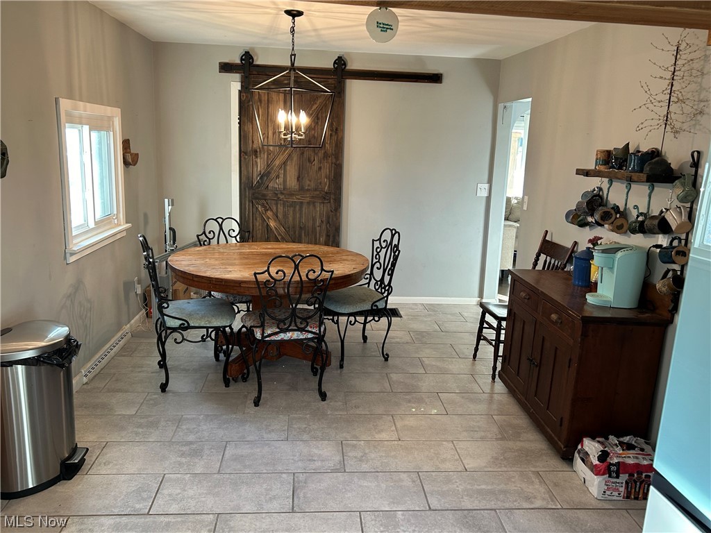 1312 Aberagg Road Atwater, OH 44201 - Photo 8 of 23 Tiled dining space featuring a barn door and a chandelier