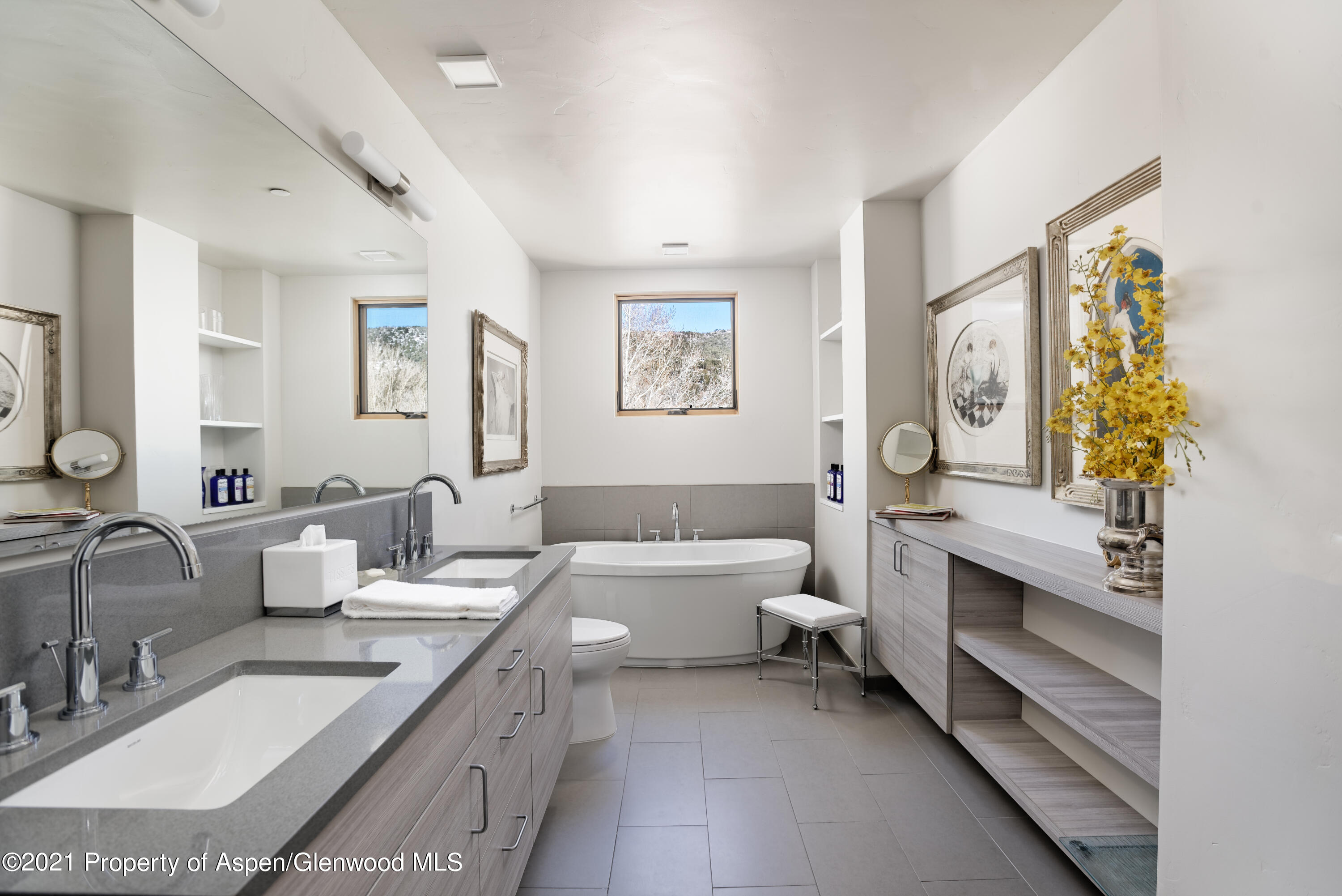 104 Evans Road, Unit 205 Basalt, CO 81621 - Photo 11 of 16 a bathroom with double vanity sinks a large mirror and a bathtub