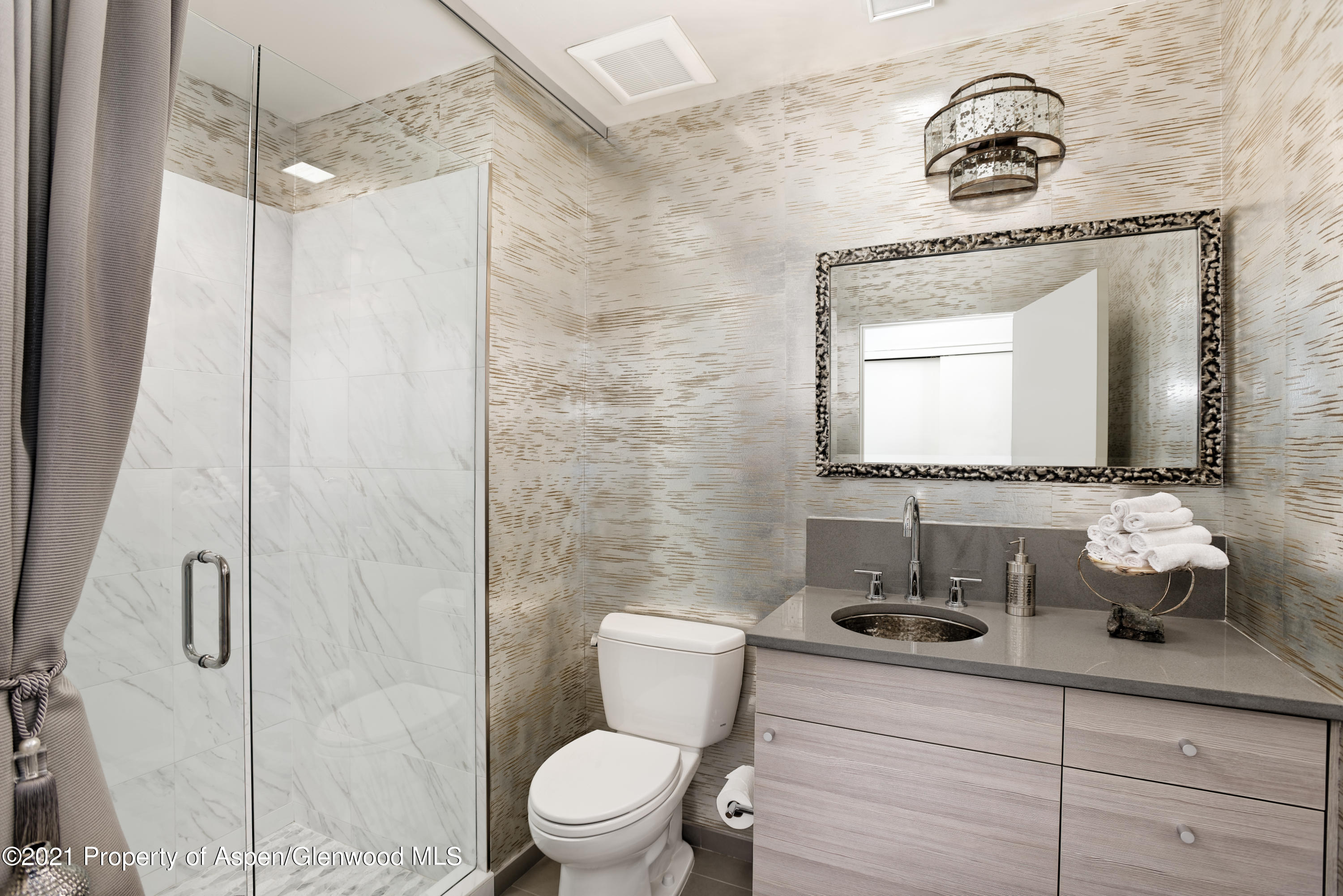 104 Evans Road, Unit 205 Basalt, CO 81621 - Photo 14 of 16 a bathroom with a toilet sink and mirror