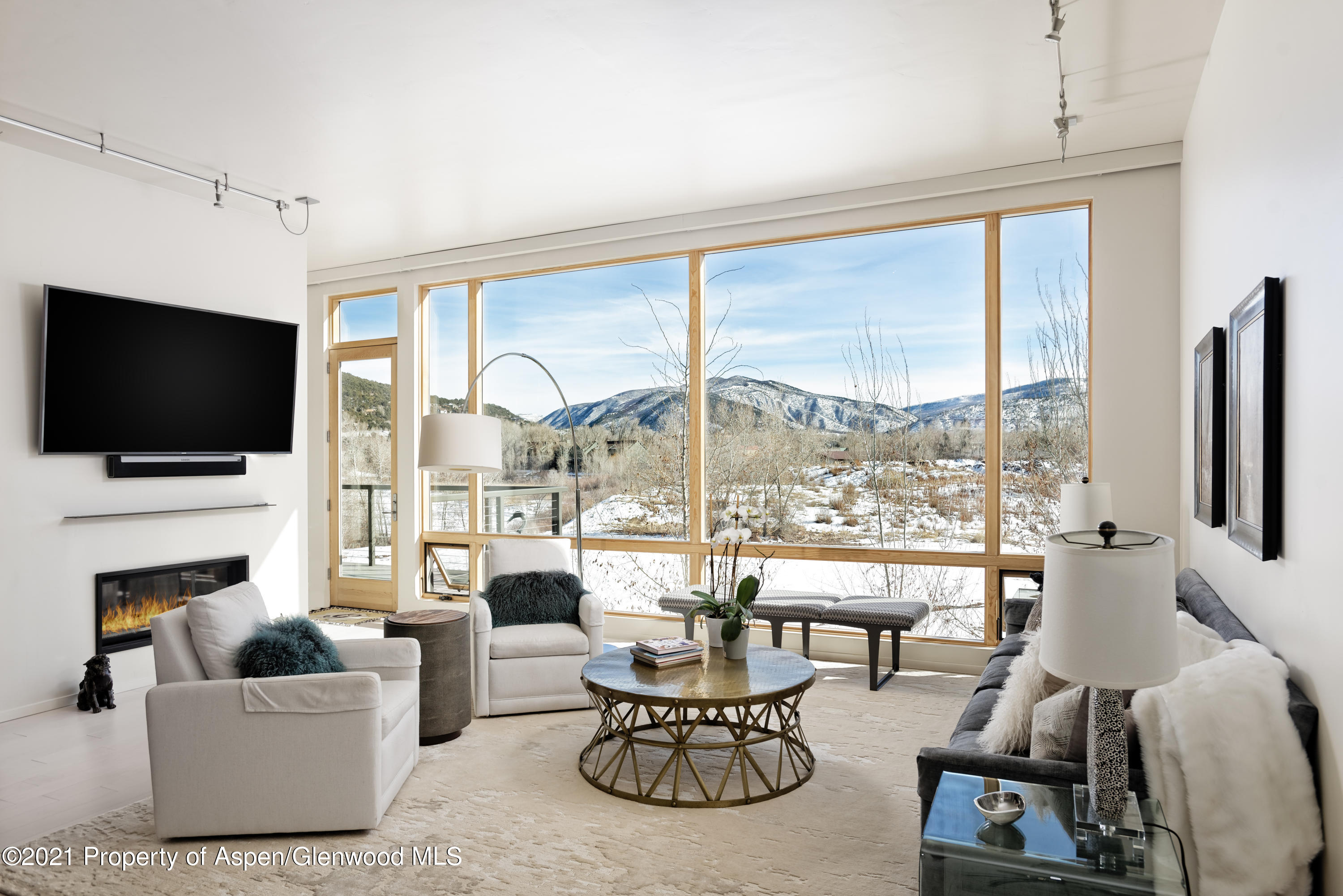 104 Evans Road, Unit 205 Basalt, CO 81621 - Photo 2 of 16 a living room with fireplace furniture and a flat screen tv
