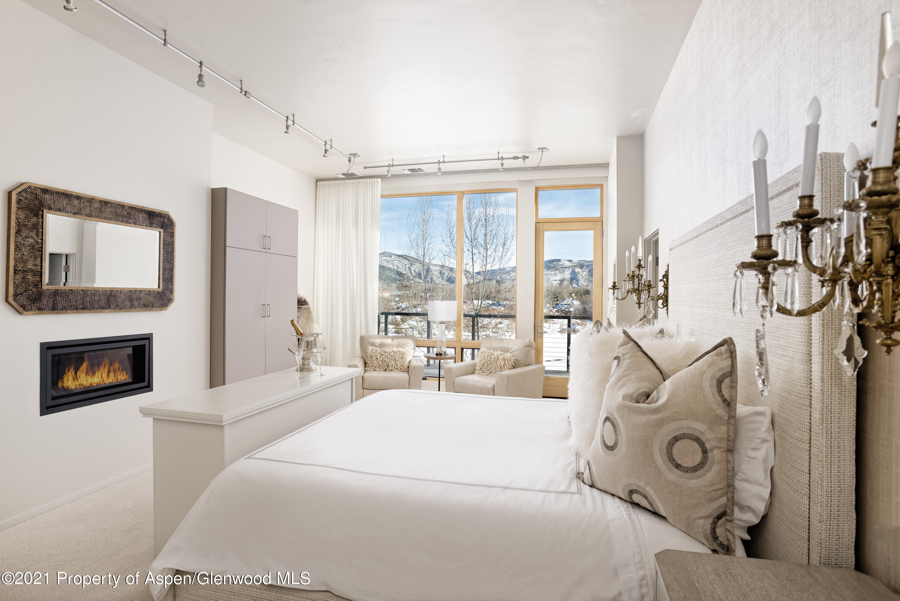 104 Evans Road, Unit 205 Basalt, CO 81621 - Photo 7 of 16 a living room with furniture a fireplace and a floor to ceiling window