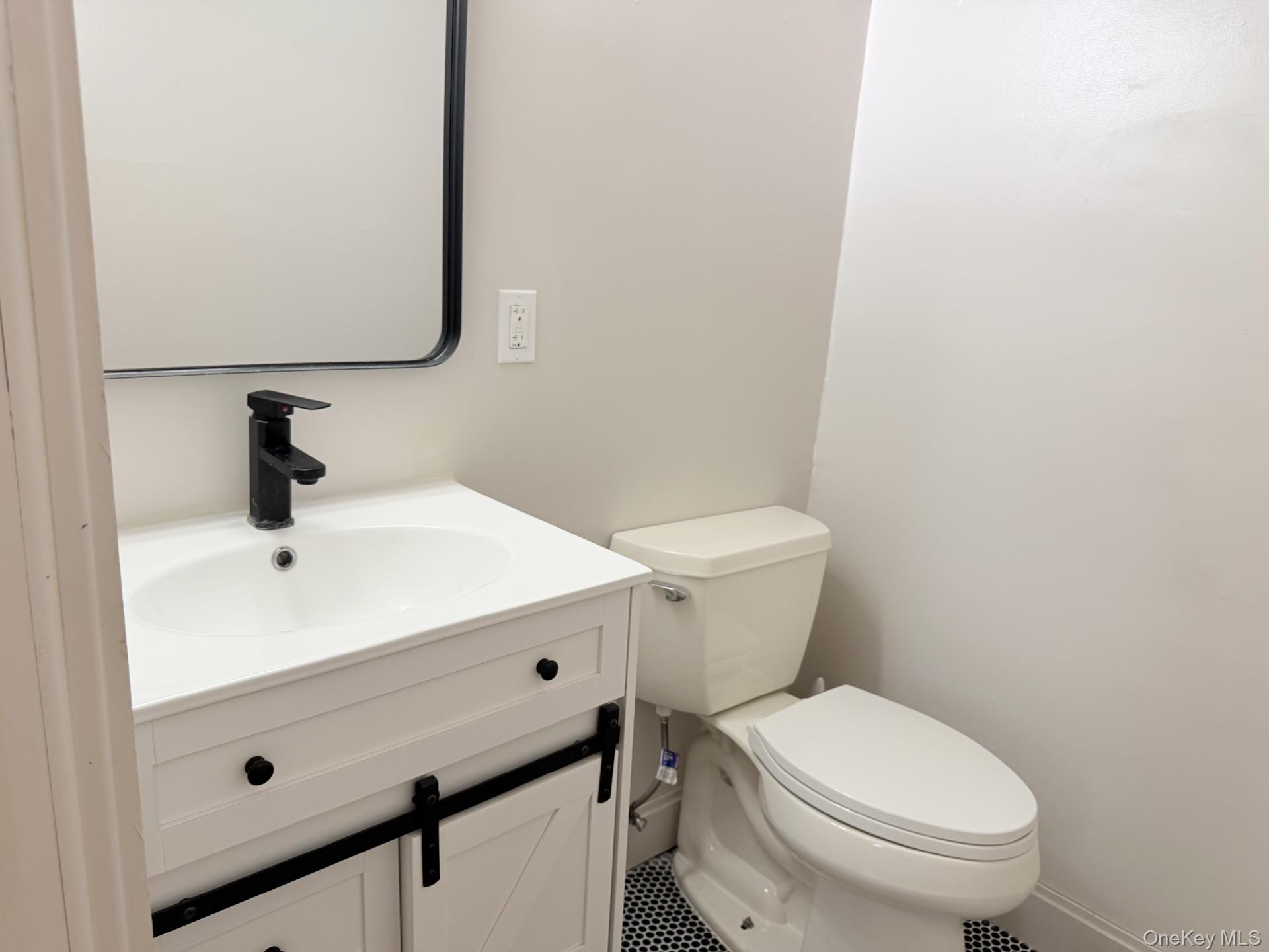 4 Lower Trinity Pass Road Pound Ridge, NY 10576 - Photo 12 of 29 a bathroom with a sink a toilet and mirror