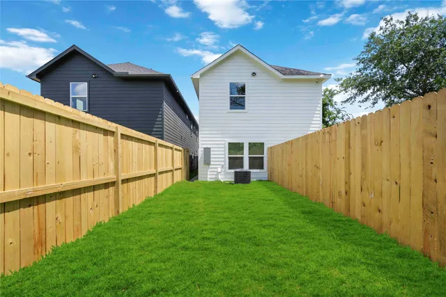 a view of a backyard with wooden fence