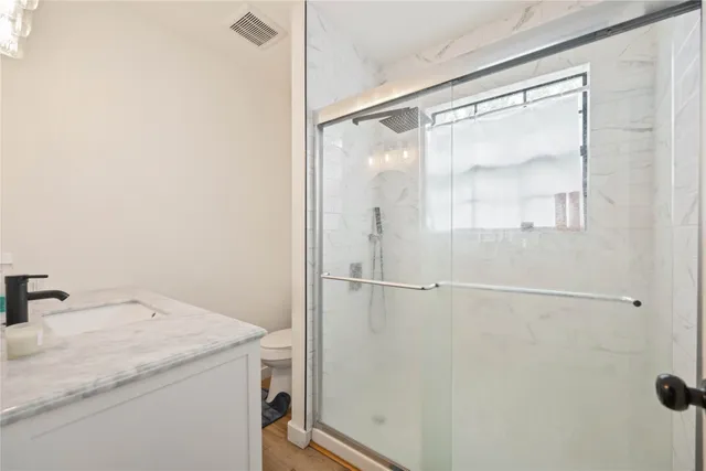 a bathroom with a shower and a sink