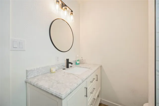 a bathroom with a sink and a mirror