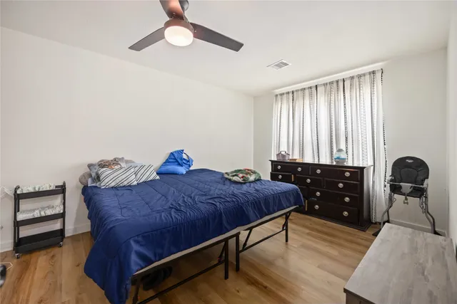 a bedroom with a bed and wooden floor