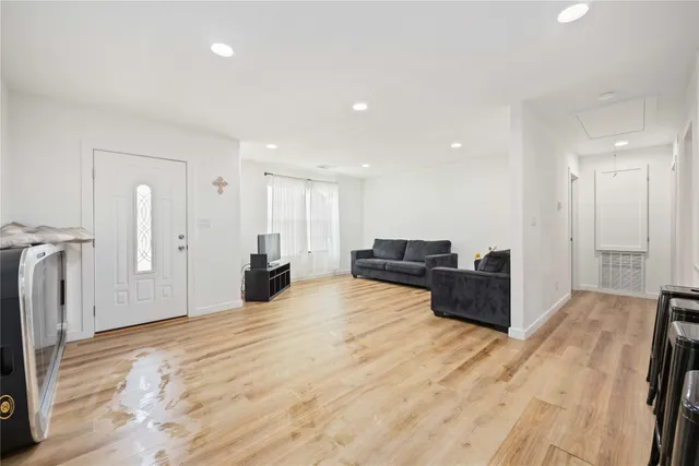 a large room with a lot of furniture and wooden floor