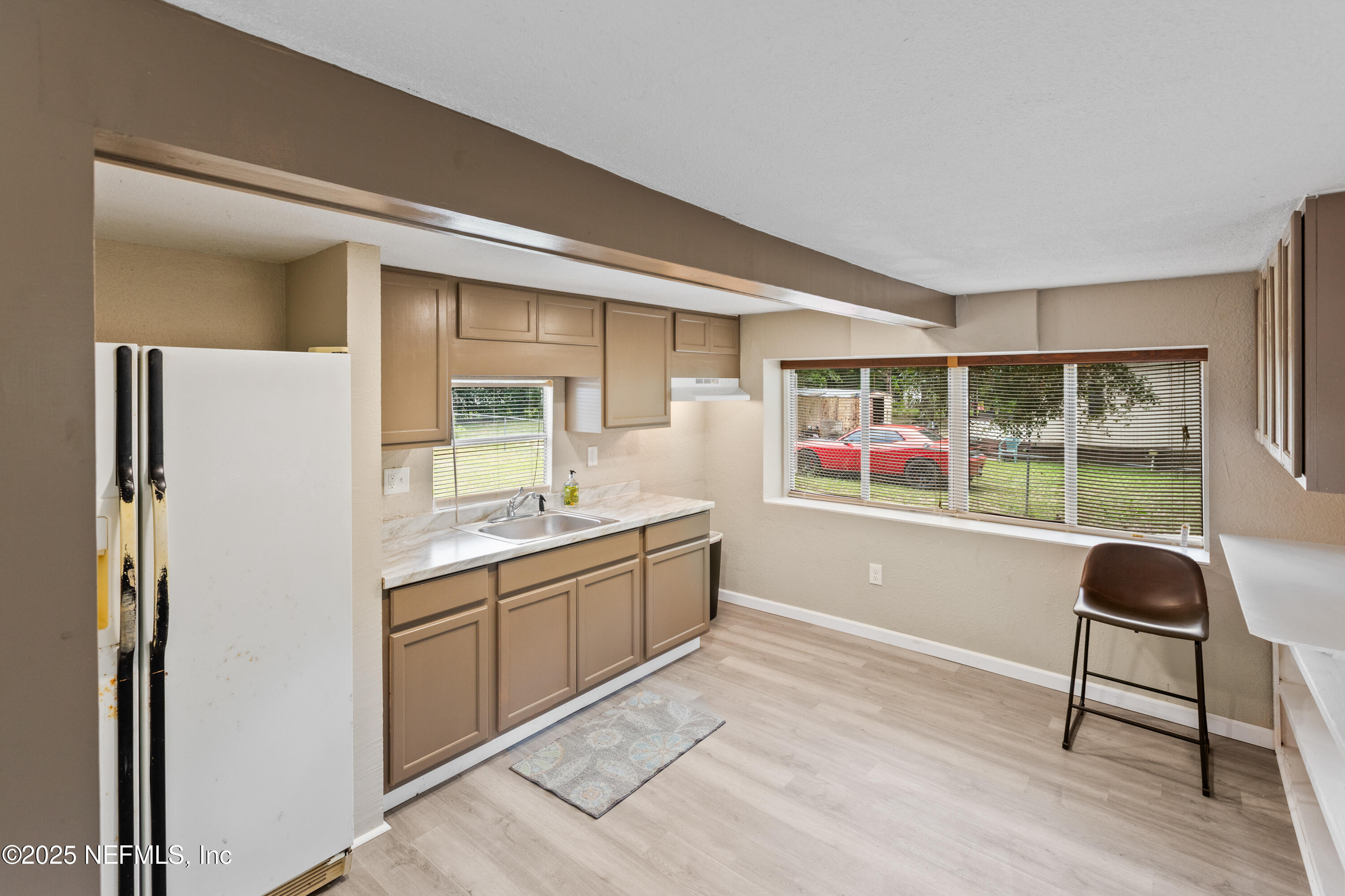 6398 Cascade Drive Keystone Heights, FL 32656 - Photo 15 of 31 a living room with stainless steel appliances granite countertop a refrigerator and a sink