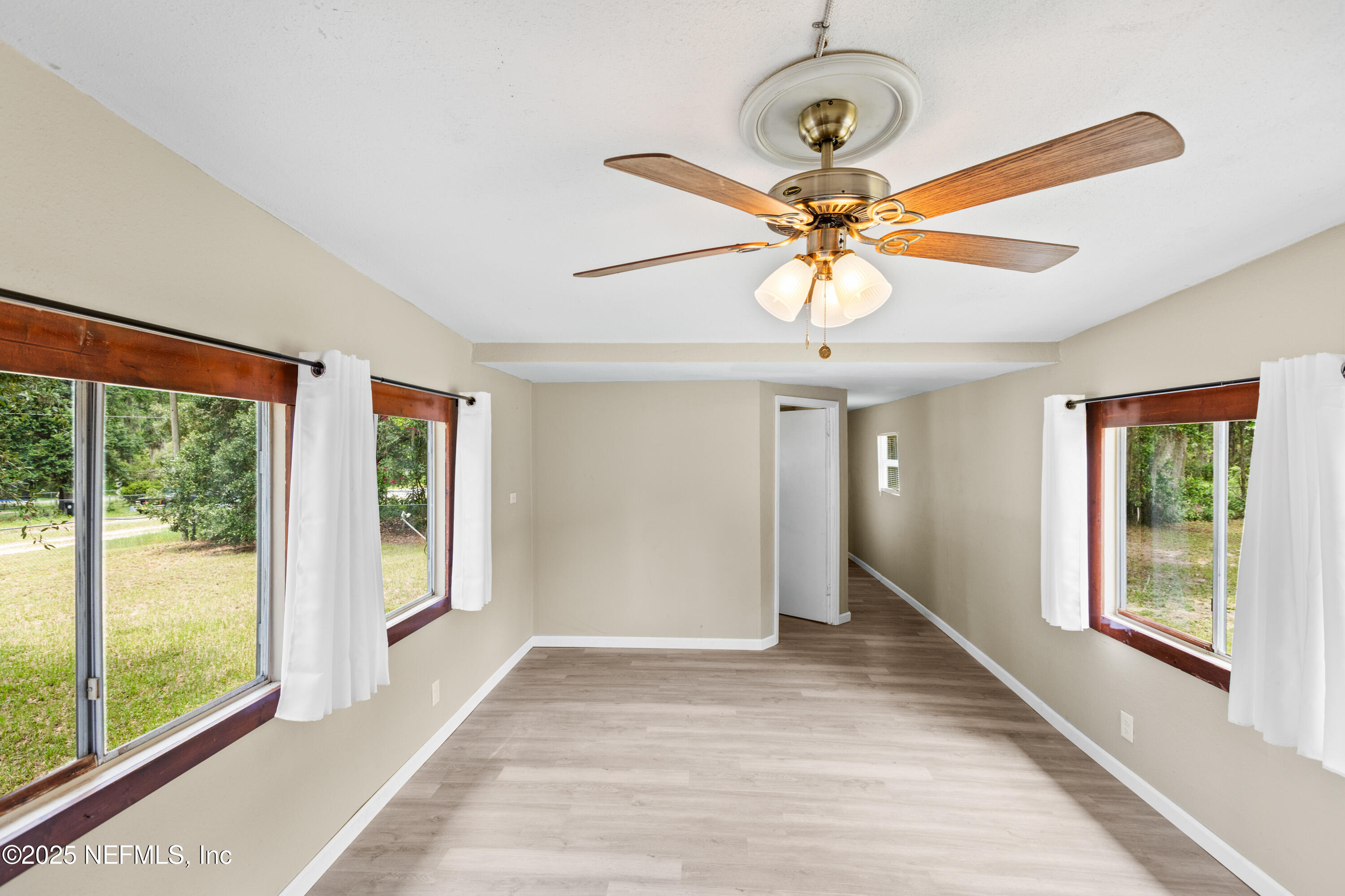 6398 Cascade Drive Keystone Heights, FL 32656 - Photo 19 of 31 a view of a livingroom with a chandelier fan and windows