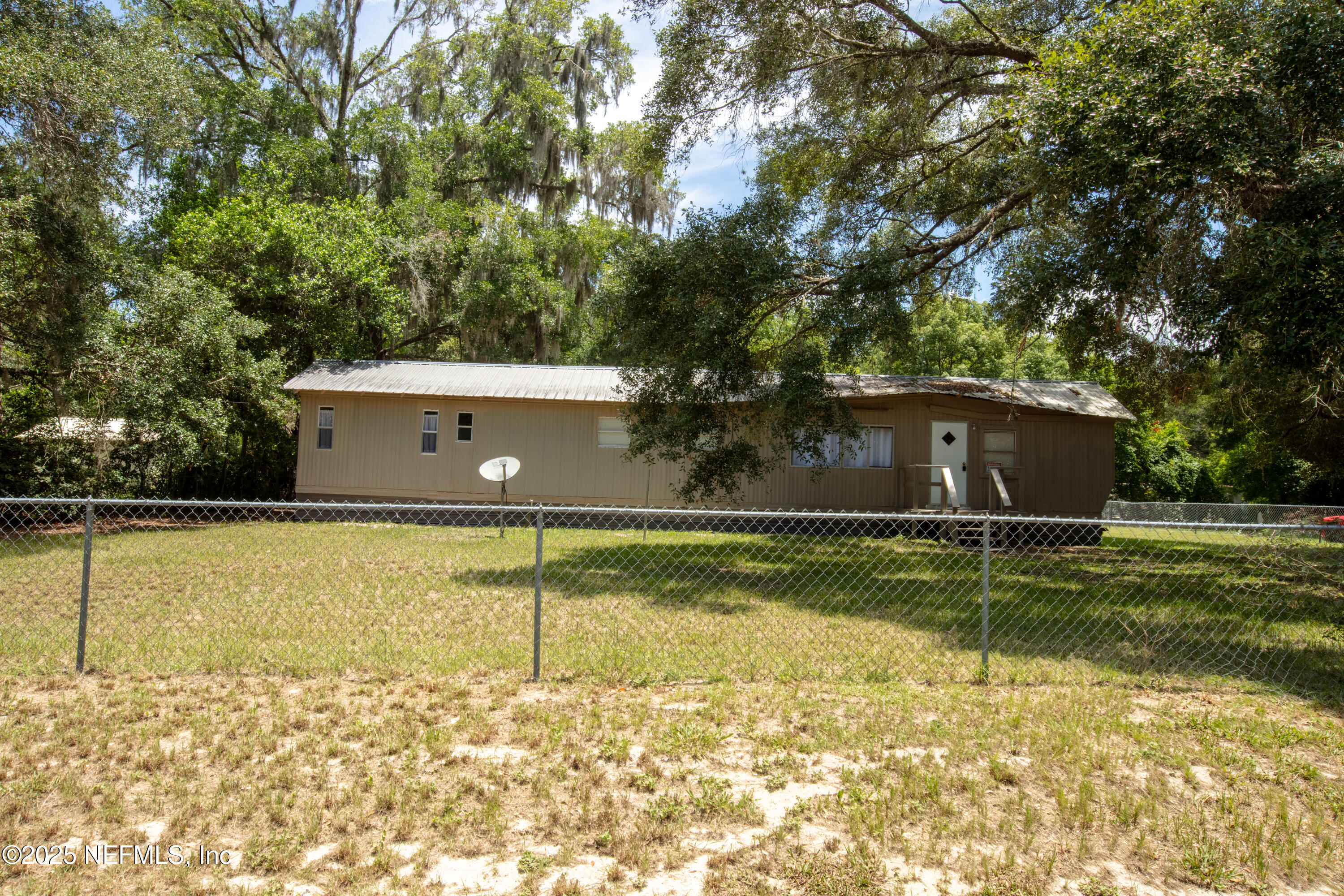 6398 Cascade Drive Keystone Heights, FL 32656 - Photo 2 of 31 a view of a swimming pool with a garden