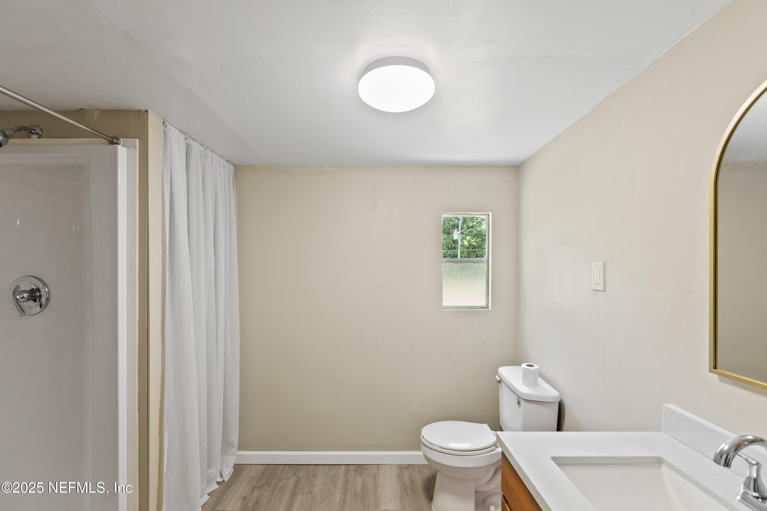 6398 Cascade Drive Keystone Heights, FL 32656 - Photo 24 of 31 a white toilet sitting next to a bathroom sink and vanity
