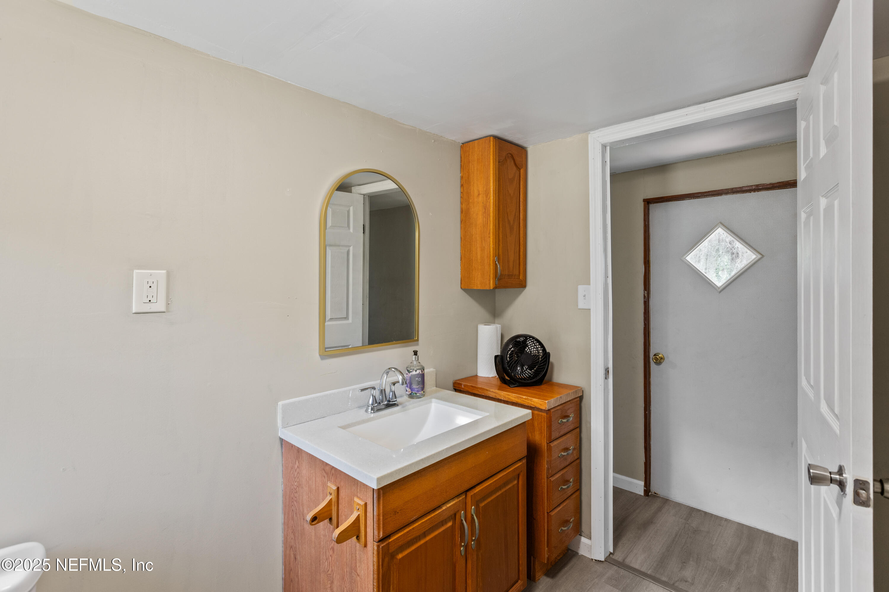 6398 Cascade Drive Keystone Heights, FL 32656 - Photo 26 of 31 a bathroom with a sink and a mirror