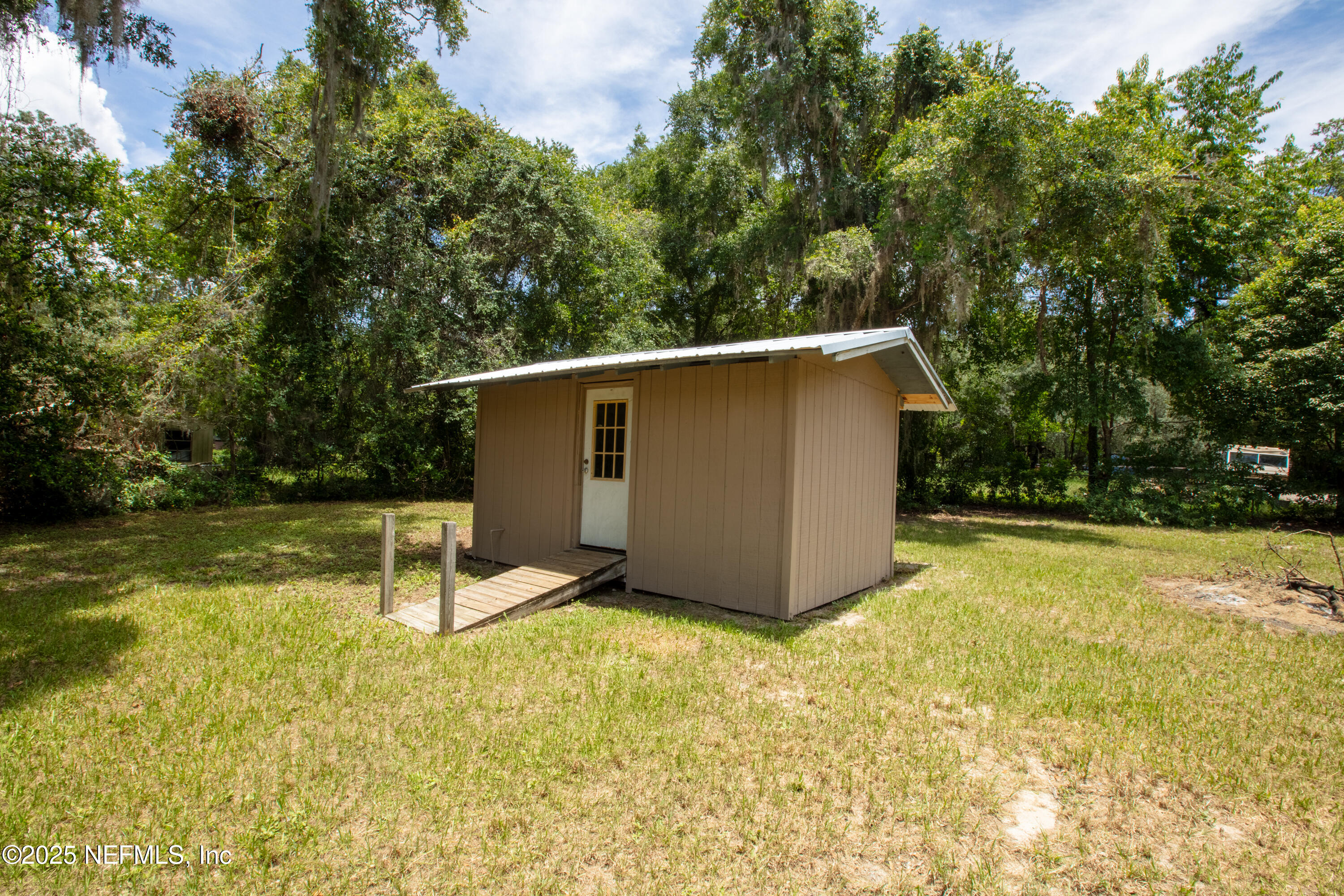6398 Cascade Drive Keystone Heights, FL 32656 - Photo 8 of 31 a view of a backyard with a small cabin