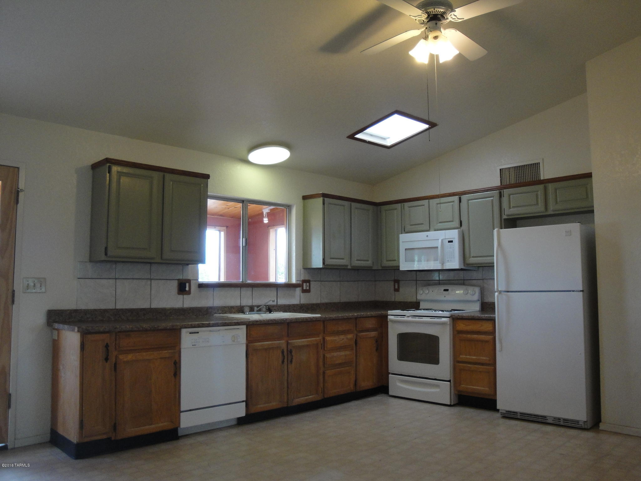 376 Via Papagayo Rio Rico, AZ 85648 - Photo 3 of 10 a kitchen with kitchen island granite countertop stainless steel appliances cabinets a sink and a counter top space