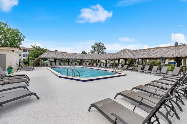 a view of a swimming pool with seating space