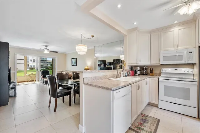 a kitchen with cabinets and chairs