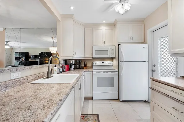 a kitchen with refrigerator and cabinets