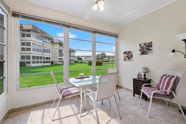a view of a backyard with a garden and chairs