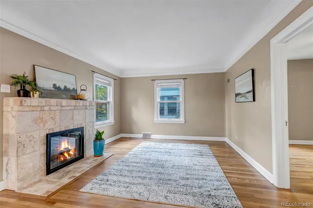a living room with a fireplace and a window