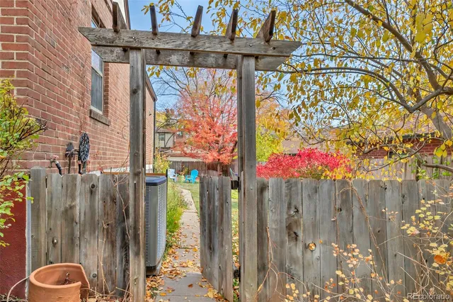 a backyard of a house with table and chairs