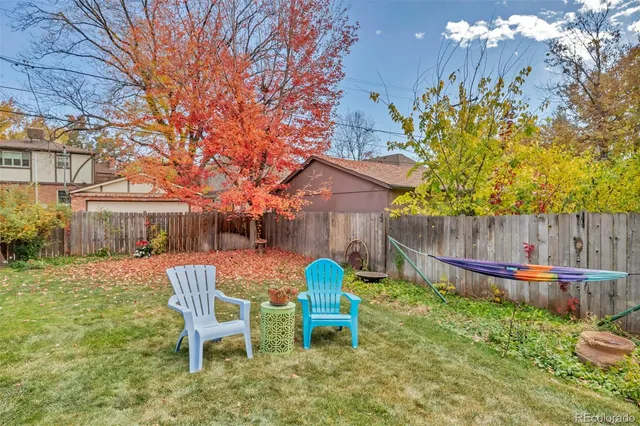 a patio with a table and chairs under an umbrella