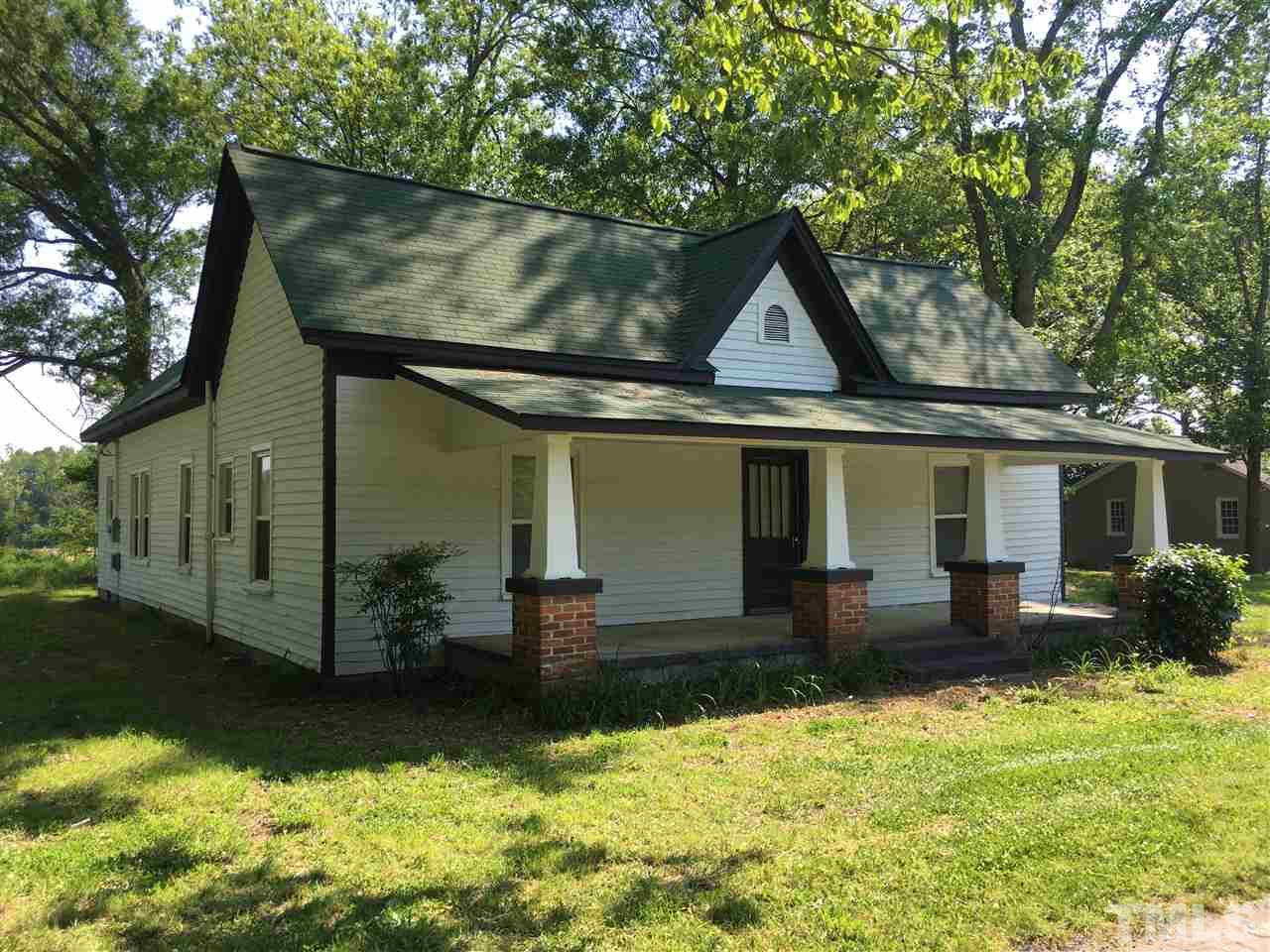 804 Pine Ridge Road Zebulon, NC 27597 - Photo 2 of 12 a front view of house with yard and trees in it