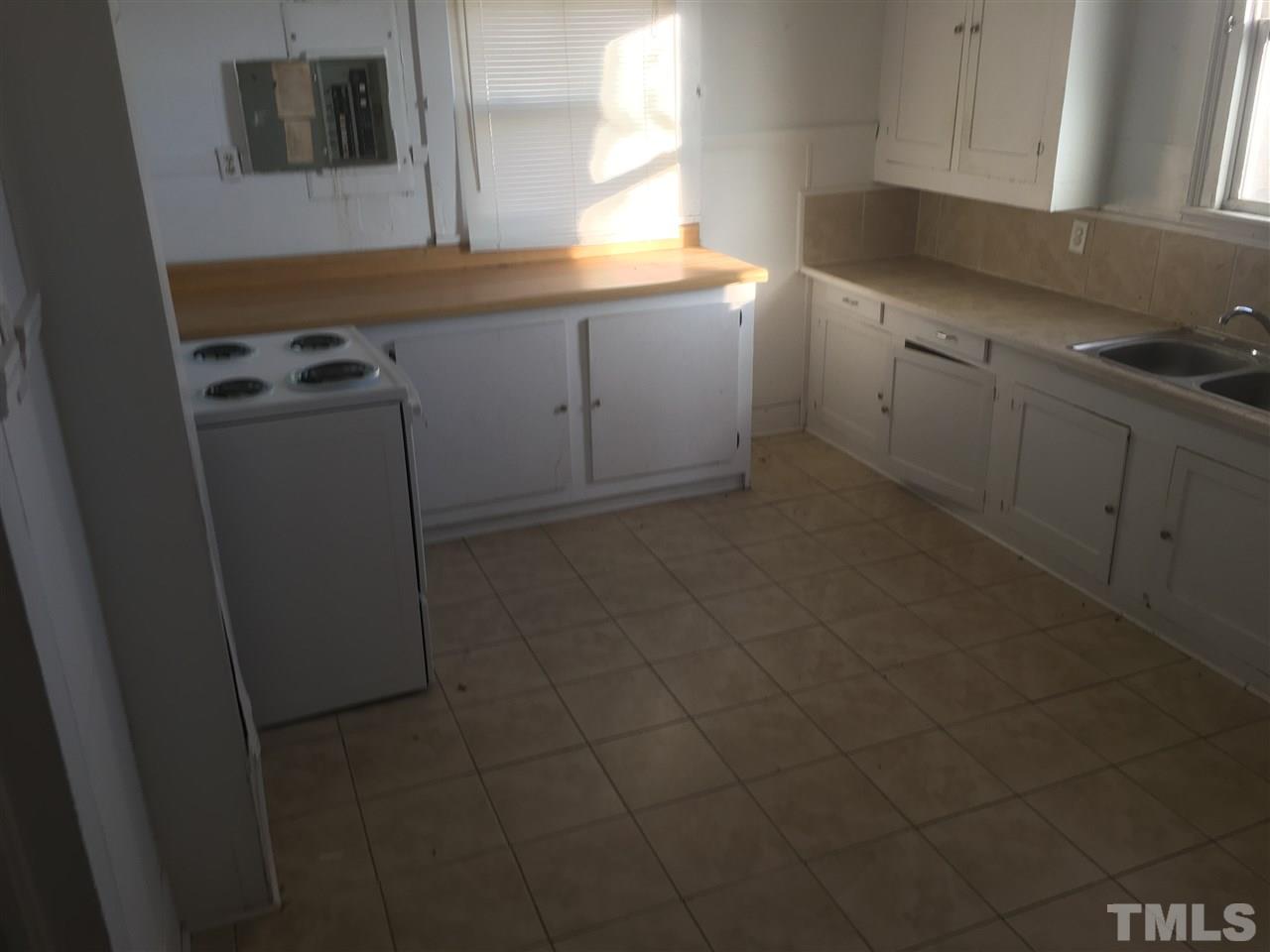 804 Pine Ridge Road Zebulon, NC 27597 - Photo 7 of 12 a kitchen with cabinets appliances and a window