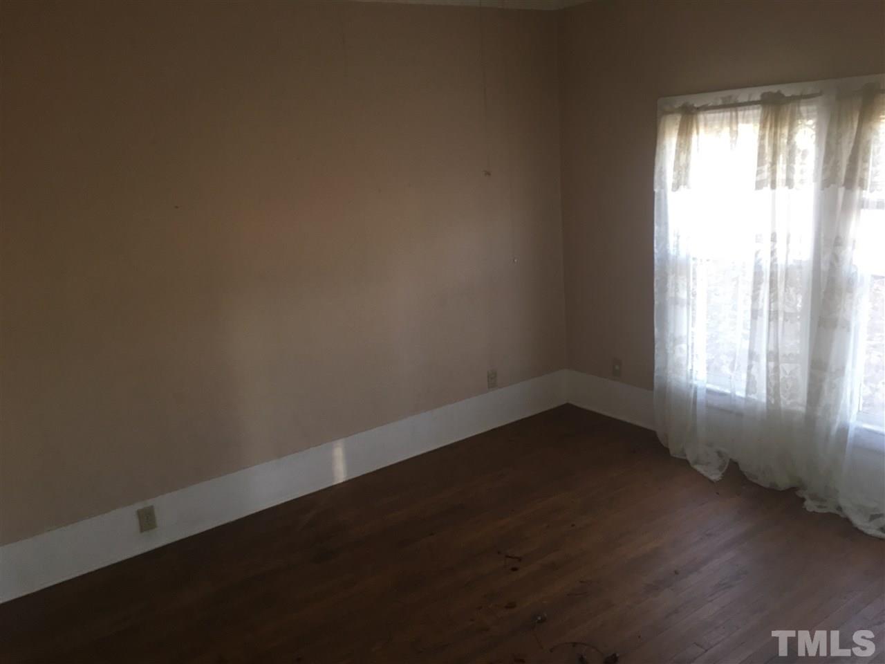 804 Pine Ridge Road Zebulon, NC 27597 - Photo 8 of 12 an empty room with a window