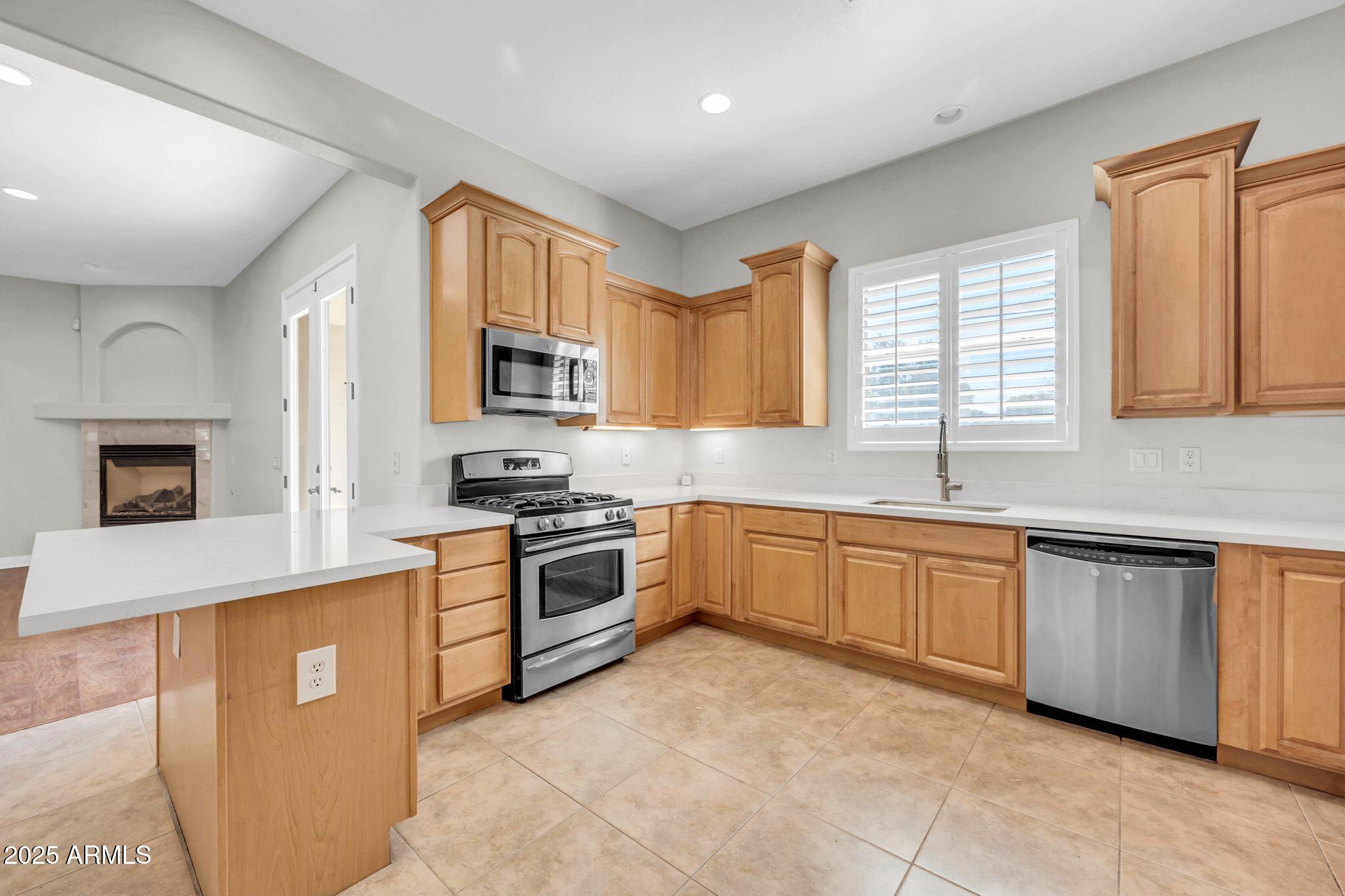4213 East Edgemont Avenue Phoenix, AZ 85008 - Photo 8 of 35 a kitchen with granite countertop a stove top oven sink and cabinets