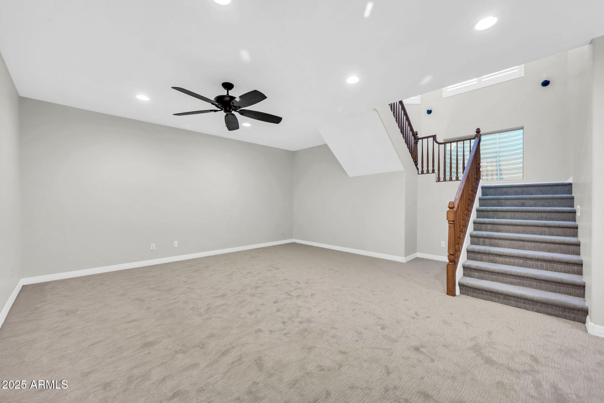 4213 East Edgemont Avenue Phoenix, AZ 85008 - Photo 10 of 35 wooden floor in an empty room with a ceiling fan