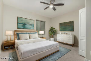 4213 East Edgemont Avenue Phoenix, AZ 85008 - Photo 14 of 35 a bedroom with a bed a mirror and a flat screen tv