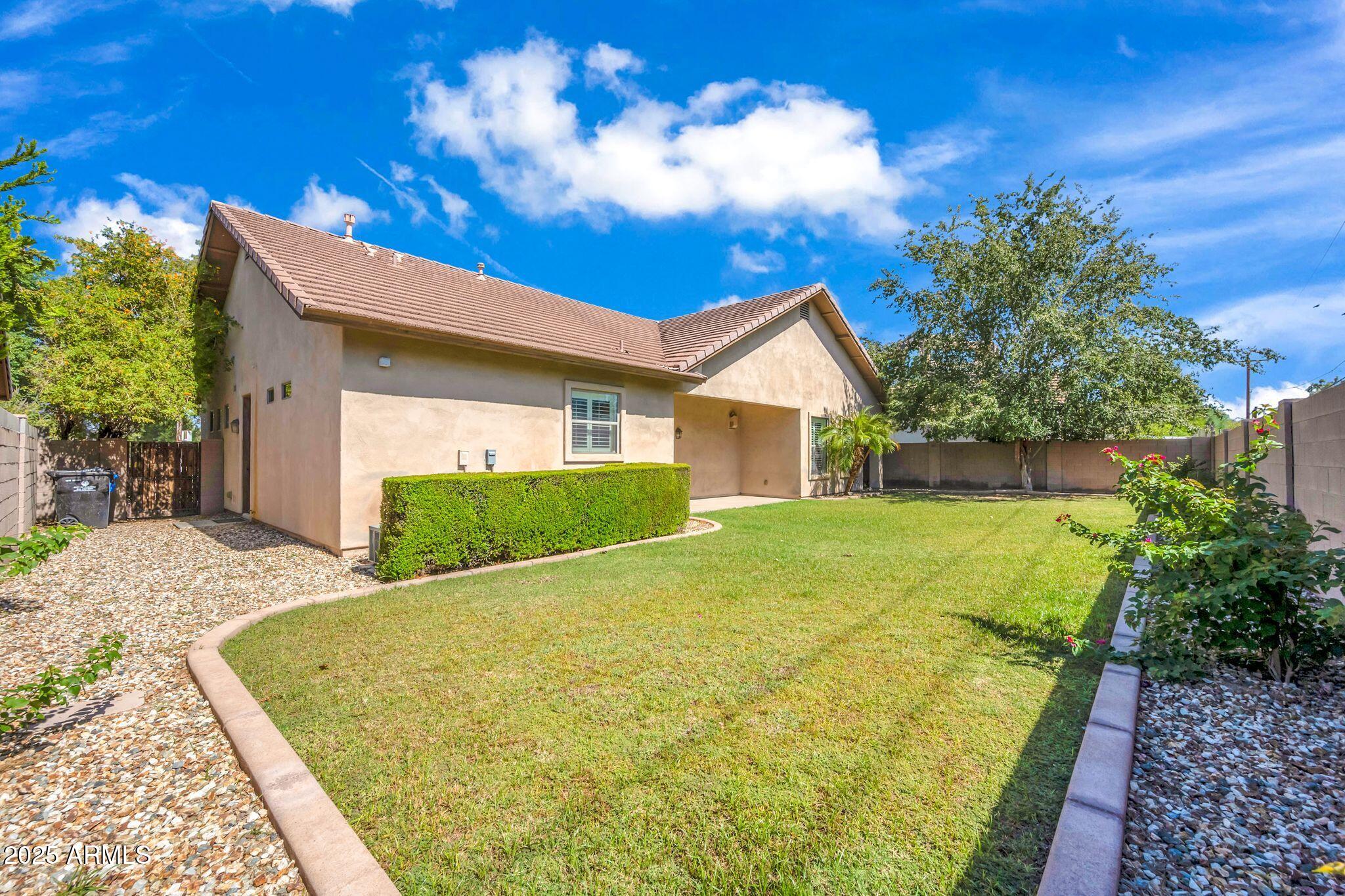4213 East Edgemont Avenue Phoenix, AZ 85008 - Photo 18 of 35 a view of backyard with a garden and trees