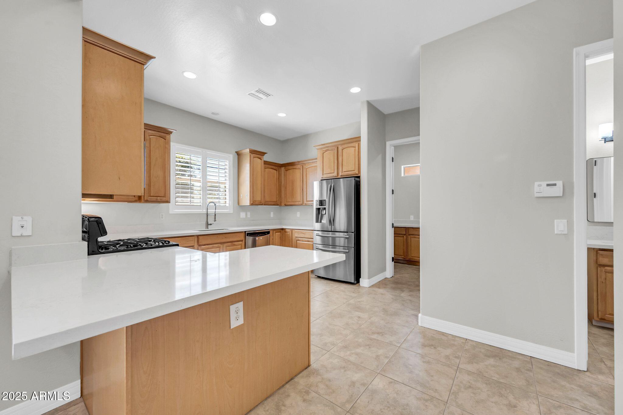 4213 East Edgemont Avenue Phoenix, AZ 85008 - Photo 7 of 35 a large kitchen with stainless steel appliances granite countertop a refrigerator a sink and a stove
