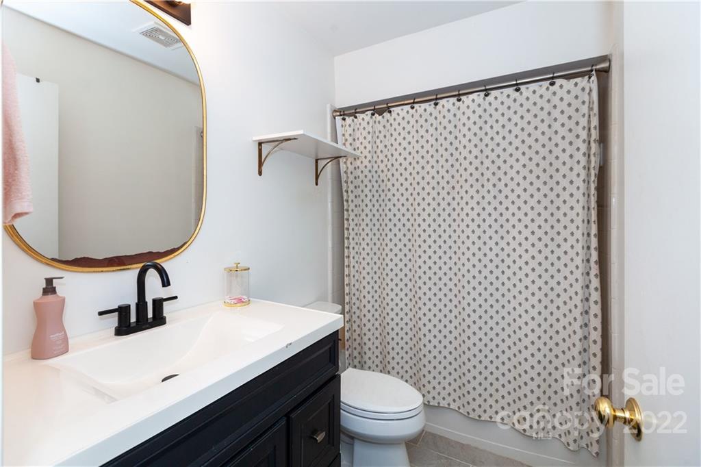 2600 Park Road, Unit C Charlotte, NC 28209 - Photo 14 of 20 a bathroom with a sink toilet and mirror