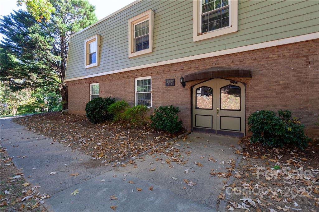 2600 Park Road, Unit C Charlotte, NC 28209 - Photo 19 of 20 a front view of a house with garden
