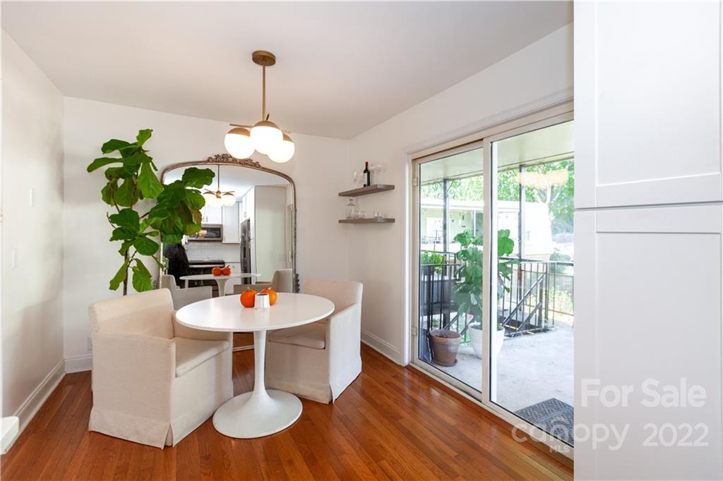 2600 Park Road, Unit C Charlotte, NC 28209 - Photo 2 of 20 a dining room with furniture potted plants and wooden floor