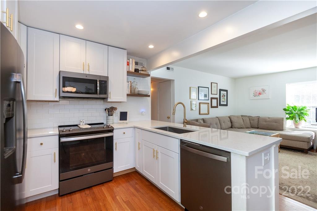 2600 Park Road, Unit C Charlotte, NC 28209 - Photo 3 of 20 a kitchen with granite countertop a sink and a stove top oven