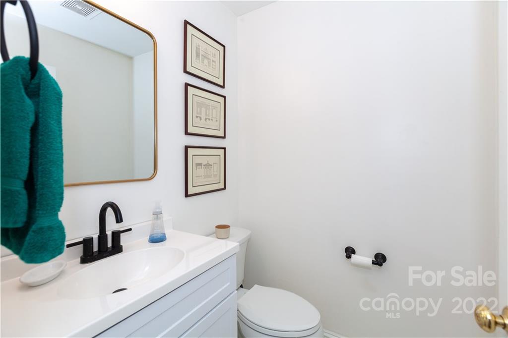 2600 Park Road, Unit C Charlotte, NC 28209 - Photo 10 of 20 a bathroom with a sink mirror vanity and toilet
