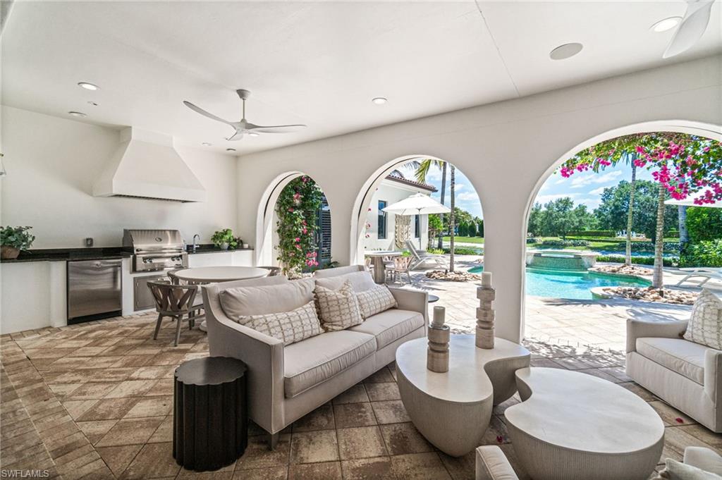 16755 Lucarno Way Naples, FL 34110 - Photo 27 of 50 a living room with fireplace furniture and a large window