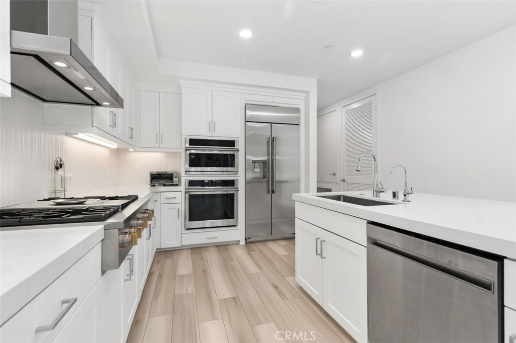 1202 Rivington Irvine, CA 92612 - Photo 10 of 52 a kitchen with stainless steel appliances a sink stove and cabinets