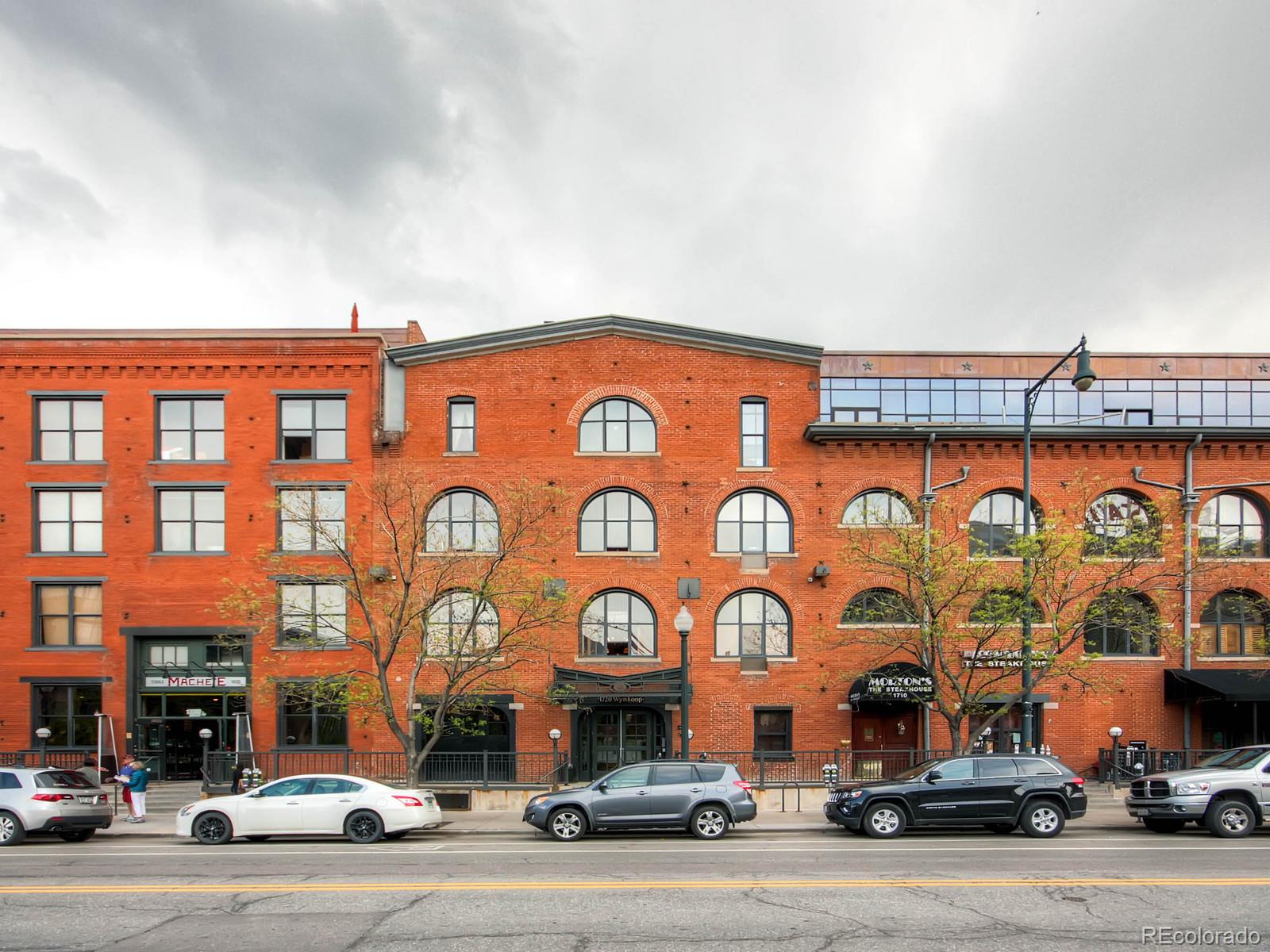 a couple of cars parked in front of building