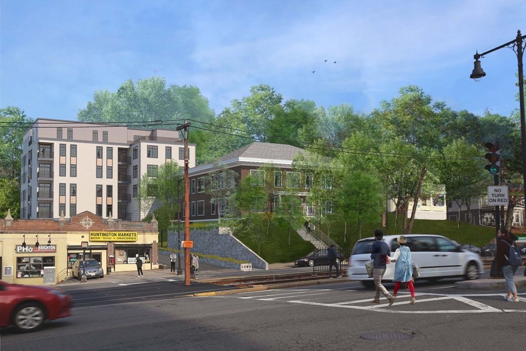 a view of a brick house with a small yard and large trees