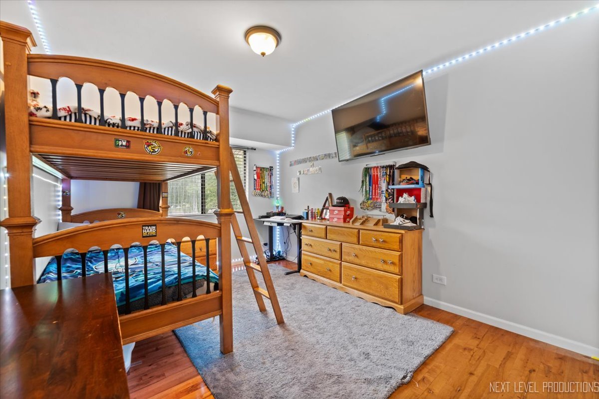 1094 Cascade Drive Aurora, IL 60506 - Photo 14 of 21 a bedroom with furniture and a flat screen tv