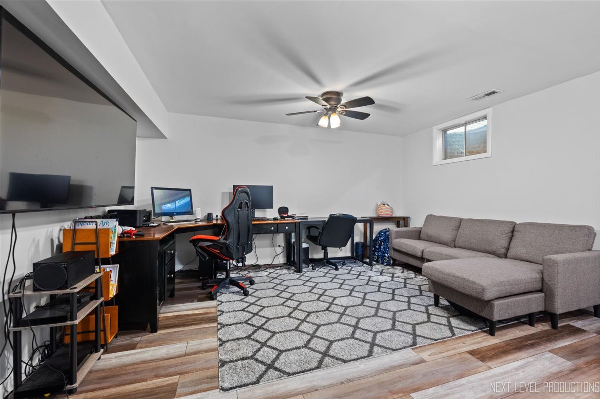 1094 Cascade Drive Aurora, IL 60506 - Photo 17 of 21 a living room with furniture a rug and a chandelier