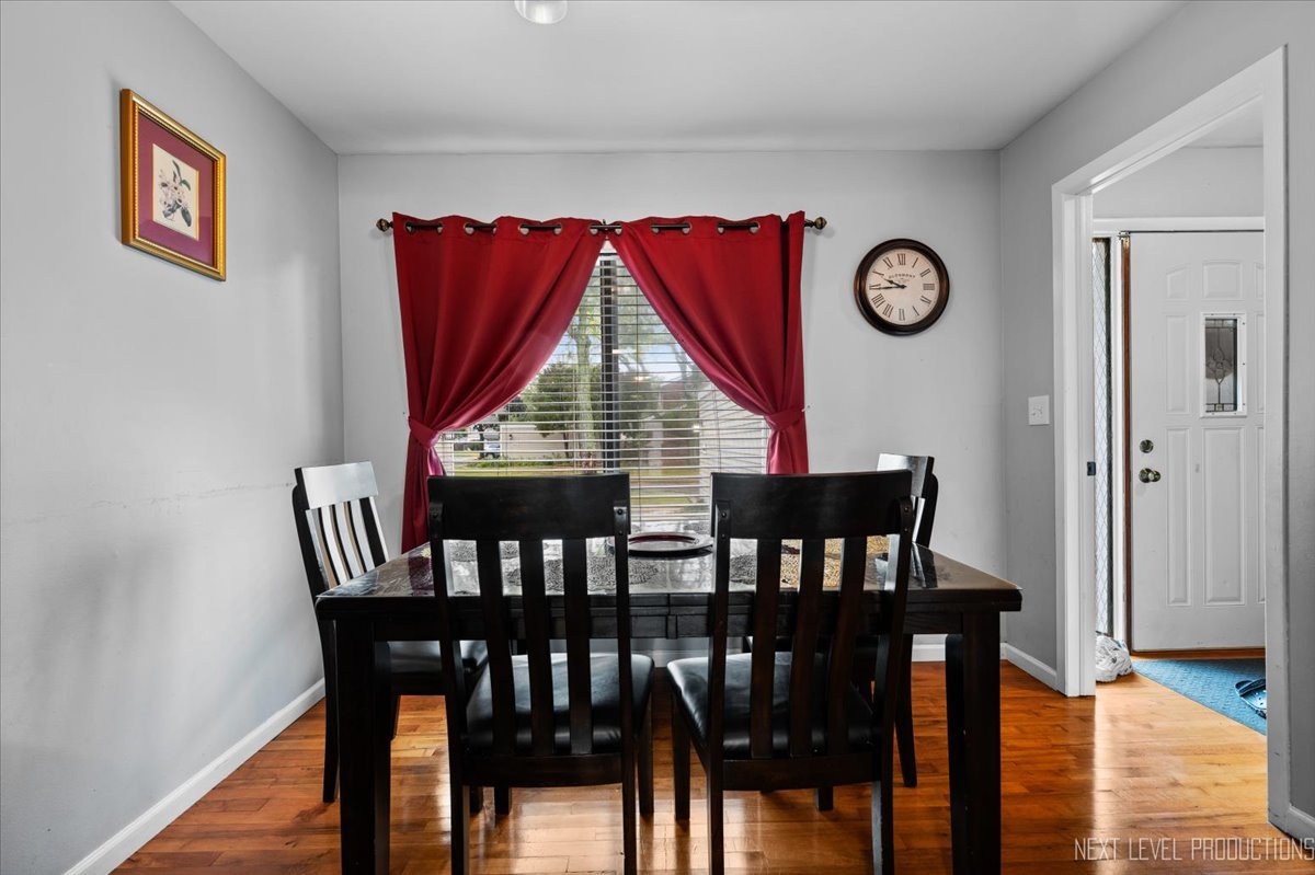 1094 Cascade Drive Aurora, IL 60506 - Photo 10 of 21 a view of a dining room with furniture and wooden floor