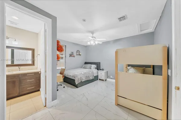 a bedroom with a large bed and a chandelier