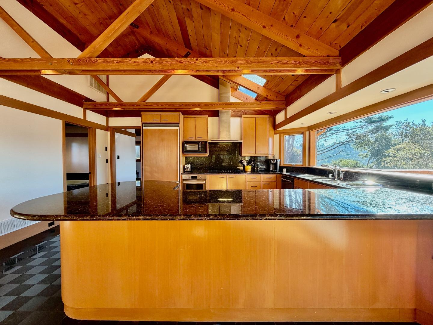 63 Berryessa Way Hillsborough, CA 94010 - Photo 15 of 39 a view of a kitchen with kitchen island a counter top a dining table and chairs
