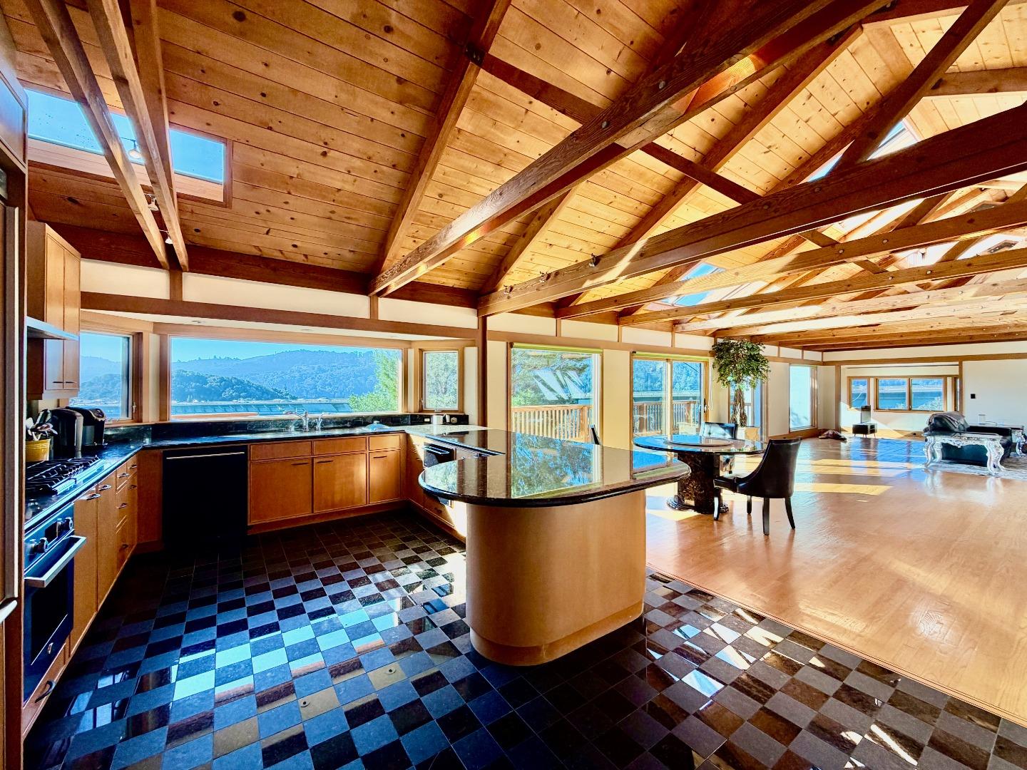 63 Berryessa Way Hillsborough, CA 94010 - Photo 17 of 39 a dining room with wooden floor furniture and a floor to ceiling window