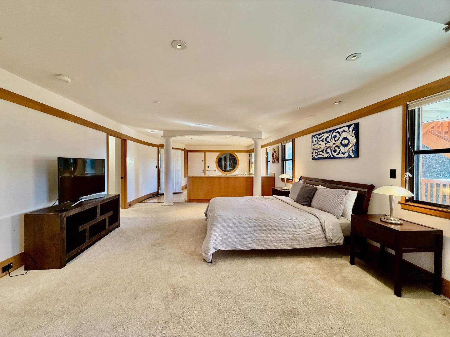 63 Berryessa Way Hillsborough, CA 94010 - Photo 29 of 39 a spacious bedroom with a bed and a flat screen television