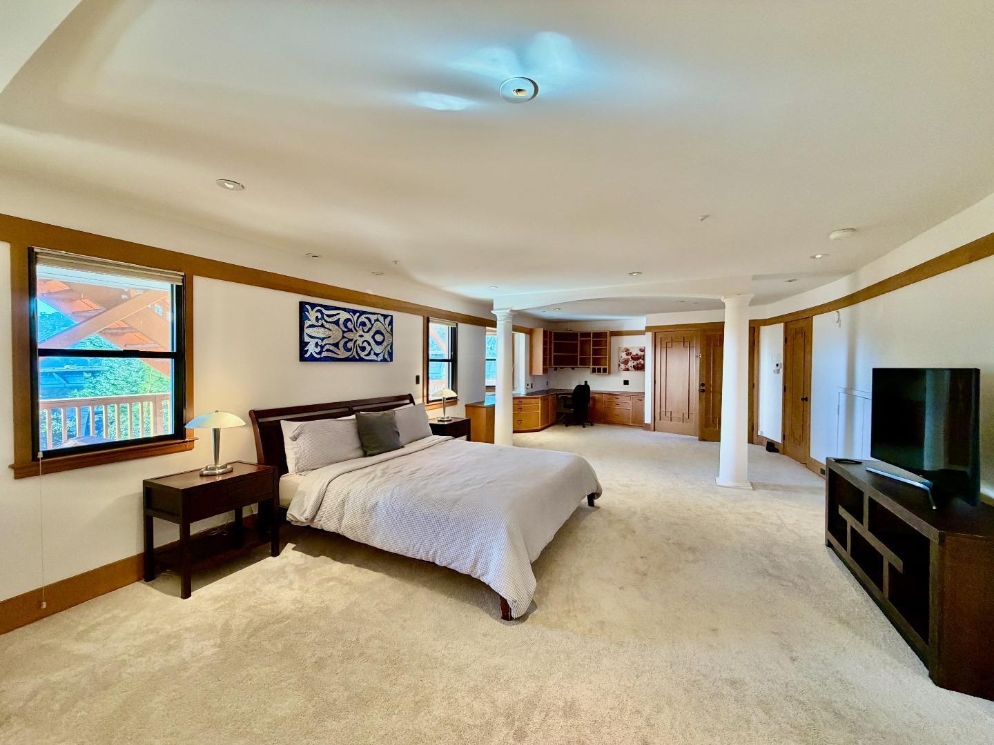 63 Berryessa Way Hillsborough, CA 94010 - Photo 31 of 39 a spacious bedroom with a bed and a flat screen television